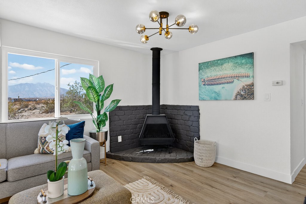 22700 Tamyran Road Desert Hot Springs, CA 92241 - Photo 14 of 65 a living room with furniture and a potted plant