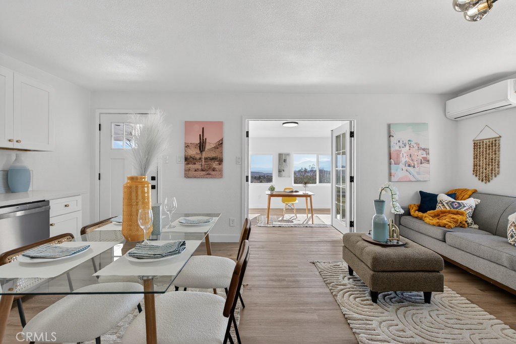 22700 Tamyran Road Desert Hot Springs, CA 92241 - Photo 15 of 65 a living room with furniture and wooden floor