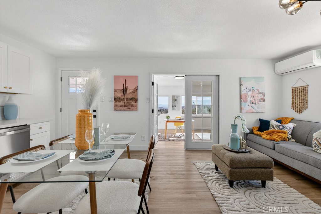 22700 Tamyran Road Desert Hot Springs, CA 92241 - Photo 16 of 65 a living room with furniture and wooden floor