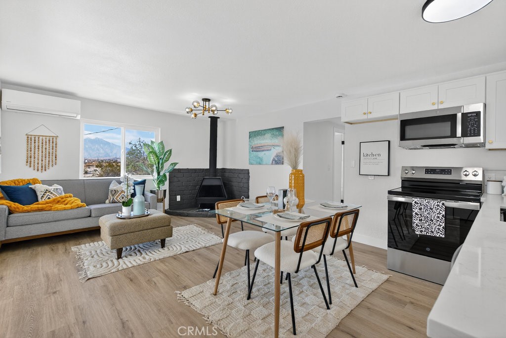 22700 Tamyran Road Desert Hot Springs, CA 92241 - Photo 18 of 65 a living room with furniture and a wooden floor