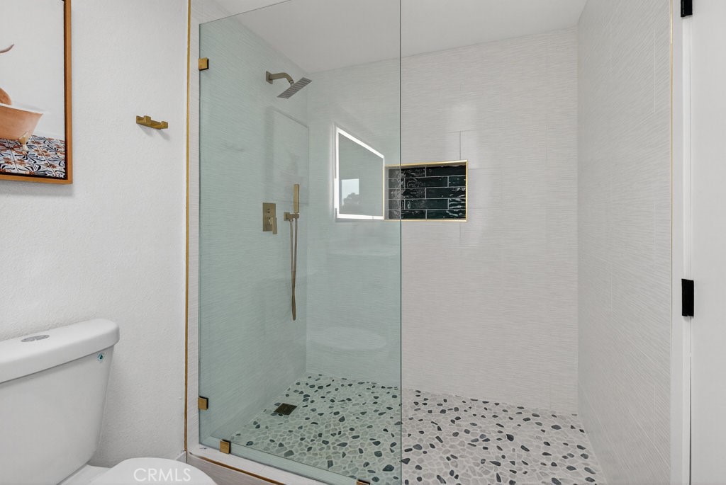 22700 Tamyran Road Desert Hot Springs, CA 92241 - Photo 2 of 65 a bathroom with a shower and a toilet