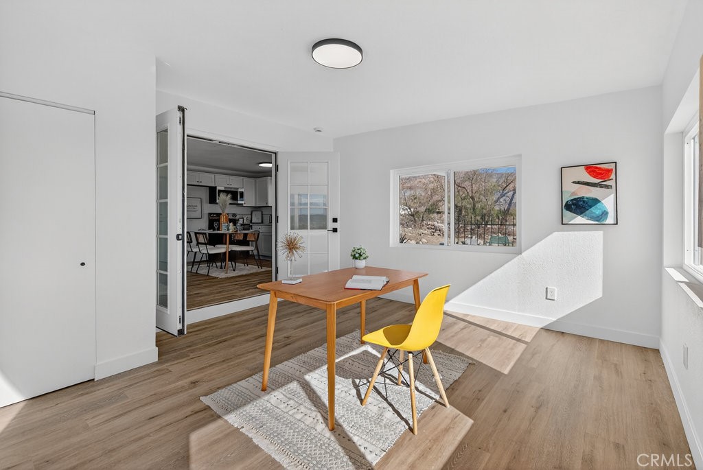 22700 Tamyran Road Desert Hot Springs, CA 92241 - Photo 27 of 65 a view of a workspace with furniture and wooden floor