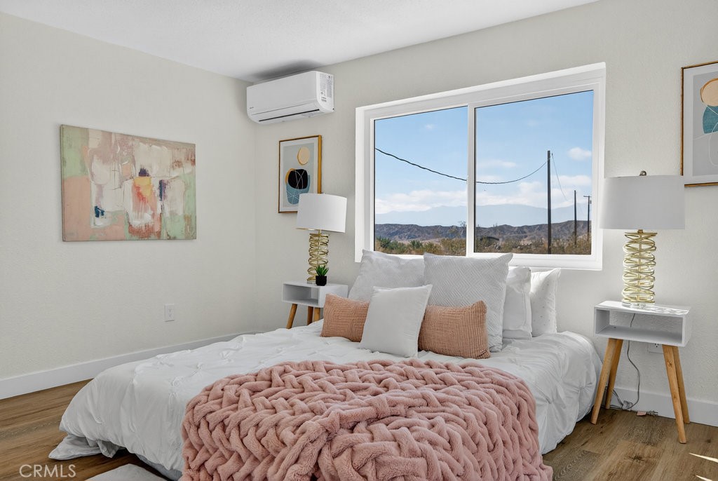22700 Tamyran Road Desert Hot Springs, CA 92241 - Photo 33 of 65 a bedroom with a large bed and a window