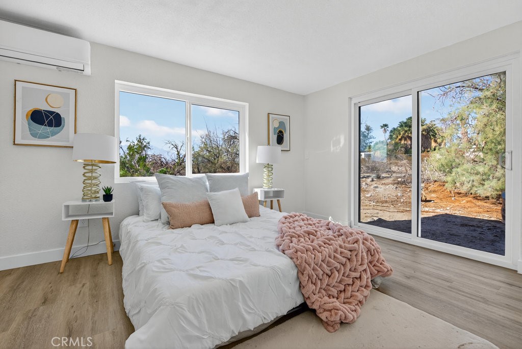 22700 Tamyran Road Desert Hot Springs, CA 92241 - Photo 34 of 65 a bedroom with a large bed and a large window