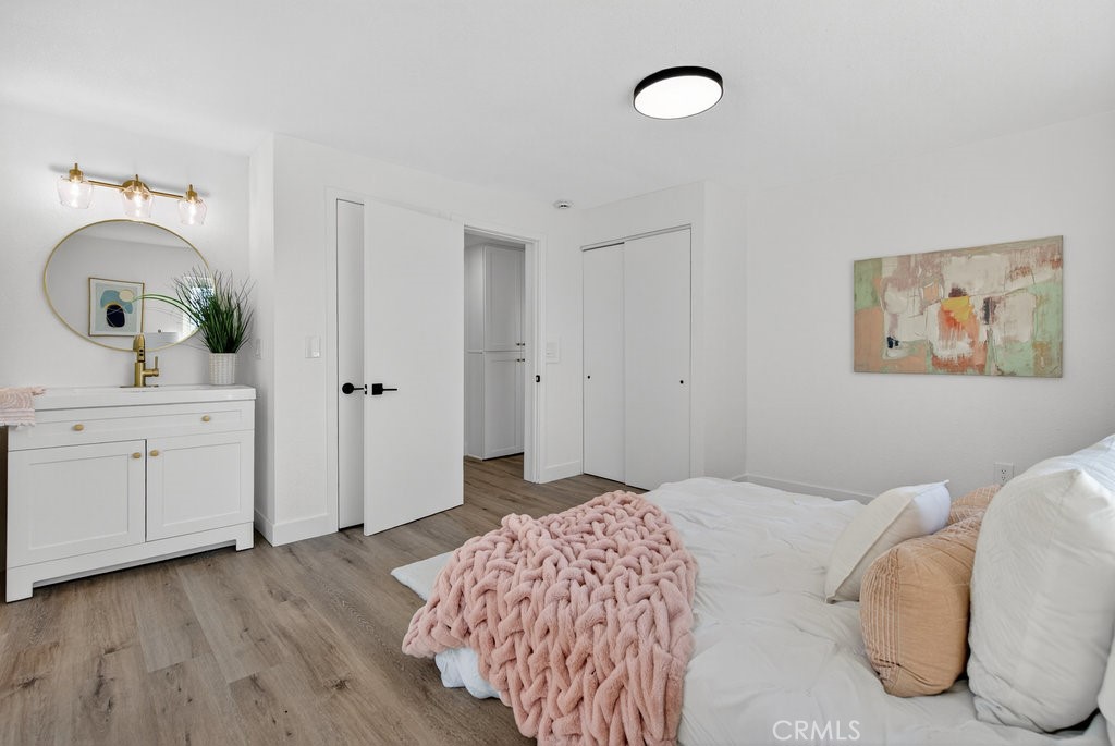 22700 Tamyran Road Desert Hot Springs, CA 92241 - Photo 36 of 65 a bedroom with a bed and a chandelier