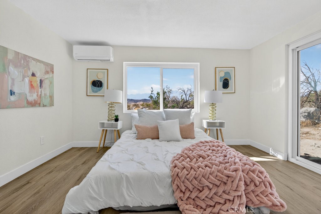 22700 Tamyran Road Desert Hot Springs, CA 92241 - Photo 38 of 65 a bedroom with a large bed and a window