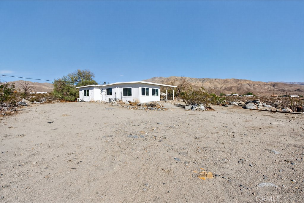 22700 Tamyran Road Desert Hot Springs, CA 92241 - Photo 42 of 65 a view of house with a yard