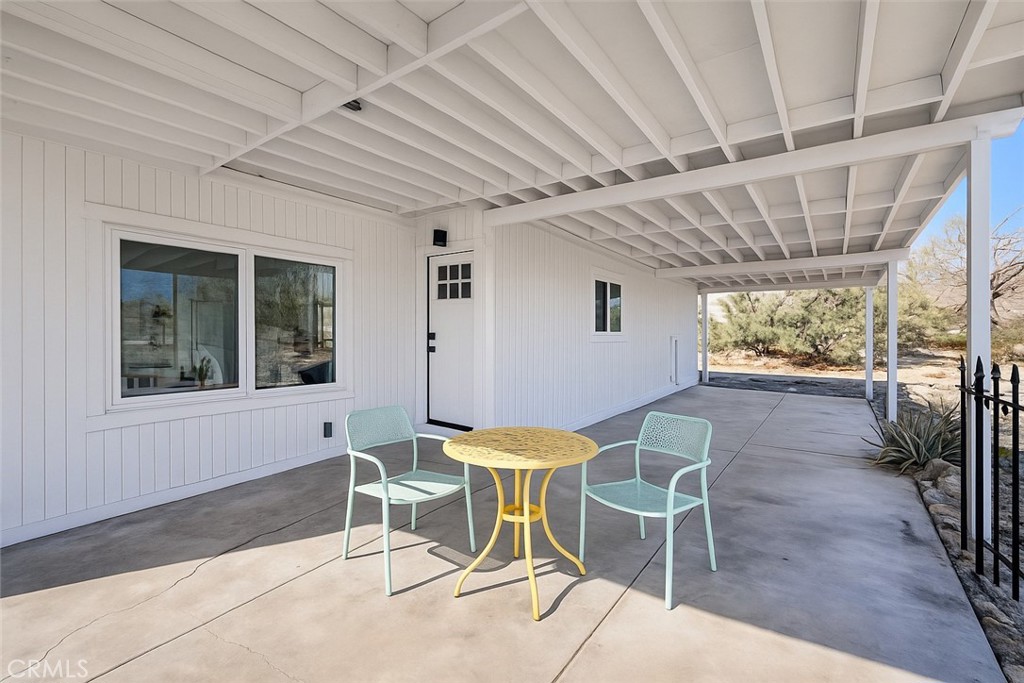 22700 Tamyran Road Desert Hot Springs, CA 92241 - Photo 45 of 65 a patio with a table and chairs