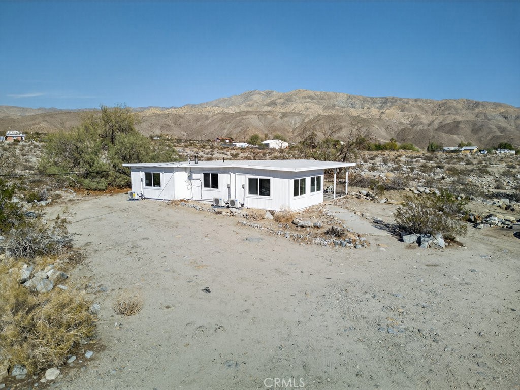 22700 Tamyran Road Desert Hot Springs, CA 92241 - Photo 49 of 65 a view of a house with a mountain