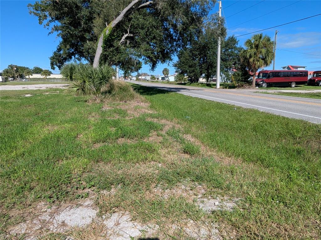 Southeast Carlstrom Field Road Arcadia, FL 34266 - Photo 6 of 14 a view of a street with a bench and trees