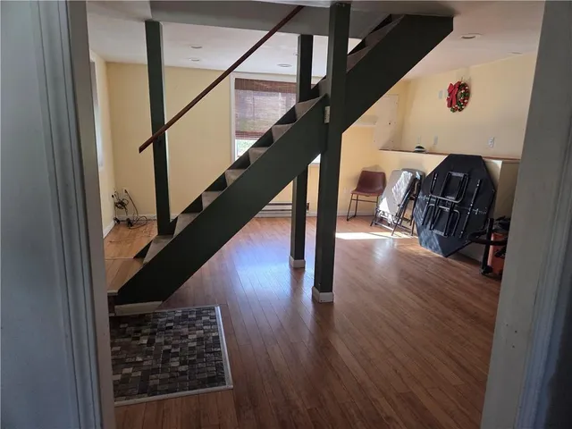 a view of entryway and hall with wooden floor