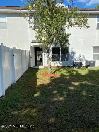 a view of a house with a big yard and a fireplace