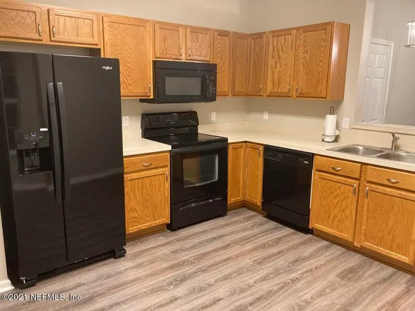a kitchen with stainless steel appliances granite countertop a refrigerator stove and sink