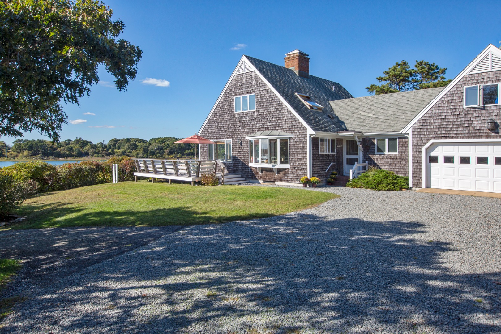 24 Litchfield Road Edgartown, MA 02539 - Photo 8 of 18 a view of house with a big yard and potted plants