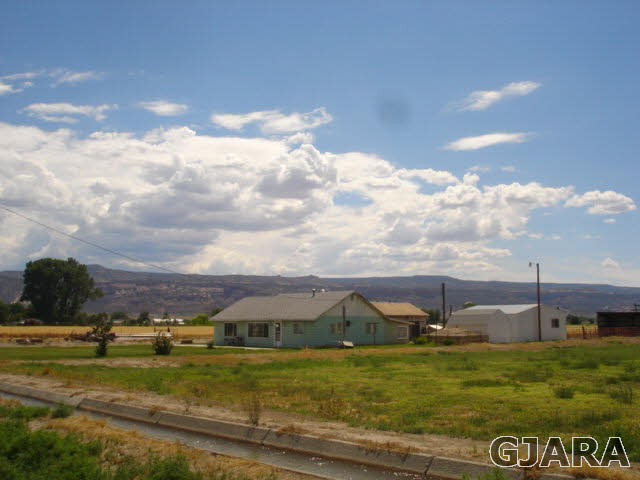 1049-19 19 1/2 Road Fruita, CO 81521 - Photo 5 of 9 a view of a town with mountains in the background