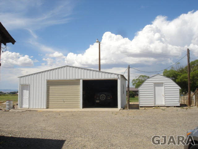 1049-19 19 1/2 Road Fruita, CO 81521 - Photo 9 of 9 a front view of a house with a yard and garage