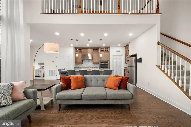 a bathroom with a toilet a sink a mirror and a window