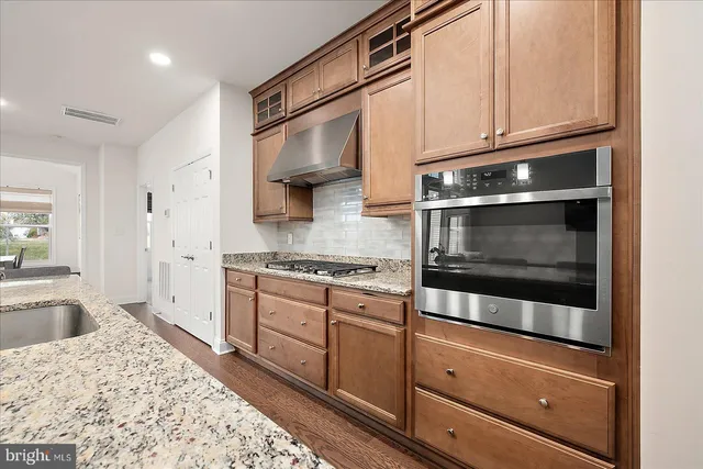 a bedroom with a large bed couch and a large window