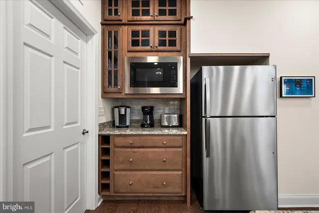 a bathroom with a granite countertop toilet sink and mirror
