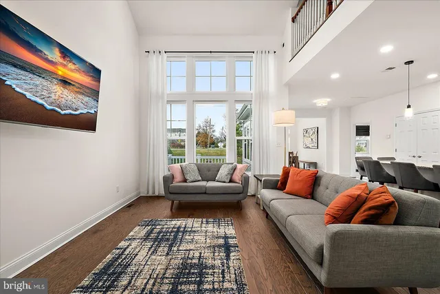 a view of a dining room with furniture a chandelier and wooden floor