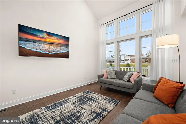 a view of a dining room with furniture wooden floor and chandelier
