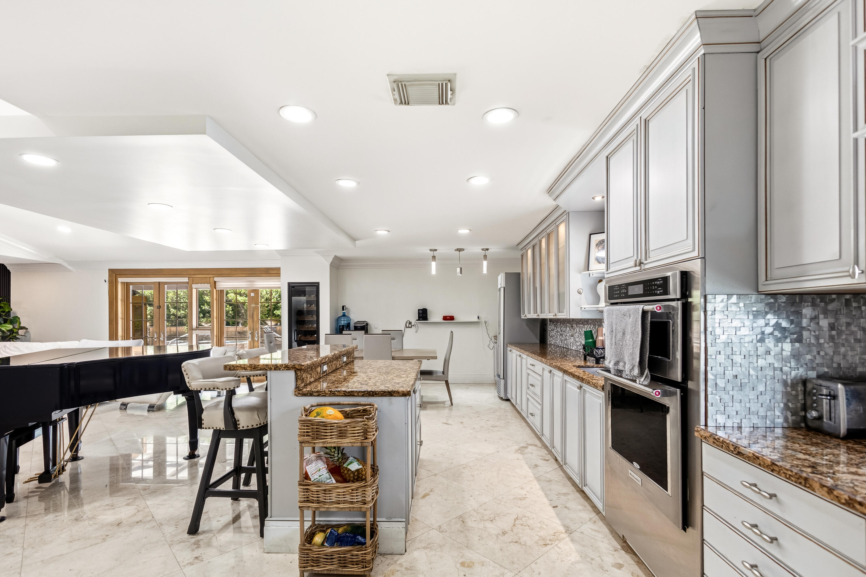 5223 Deerhurst Crescent Circle Boca Raton, FL 33486 - Photo 24 of 51 a large kitchen with stainless steel appliances lots of counter space and breakfast area
