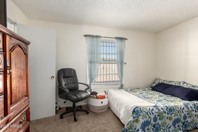 a bedroom with a bed and a window