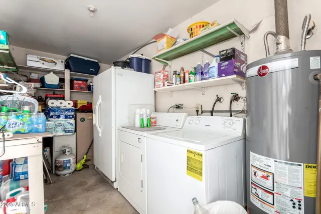 a utility room with fridge dryer and washer