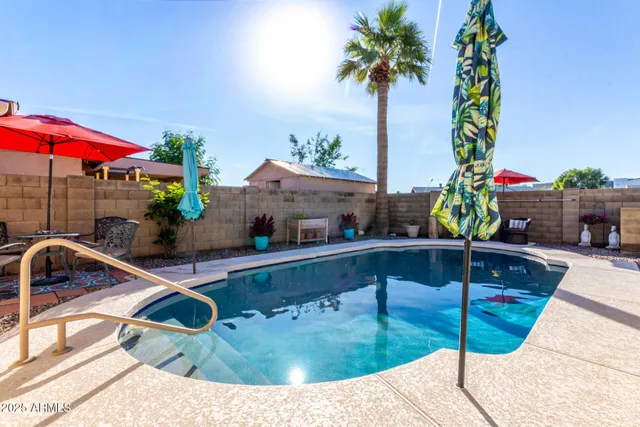 a swimming pool with outdoor seating