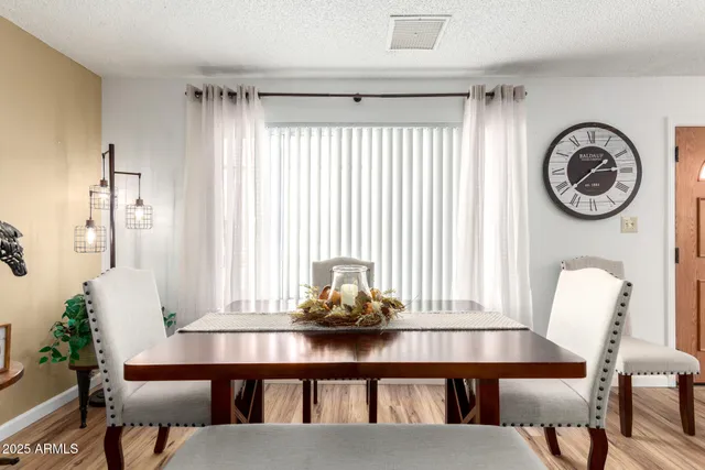 a view of a dining room with furniture and window