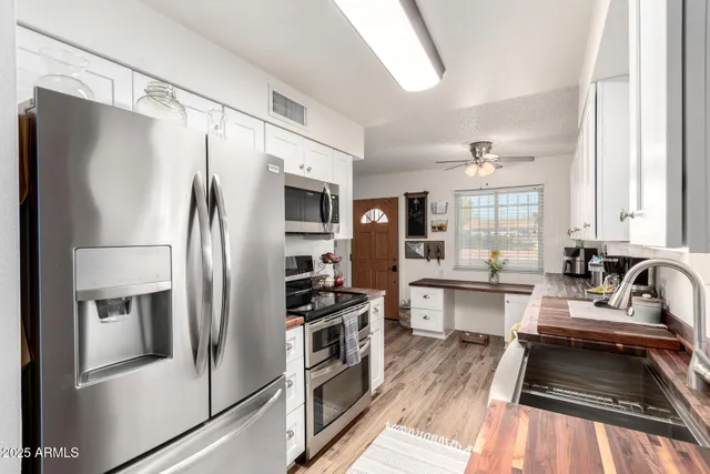 a kitchen with a refrigerator and a sink