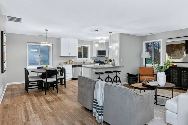 a living room with furniture and wooden floor