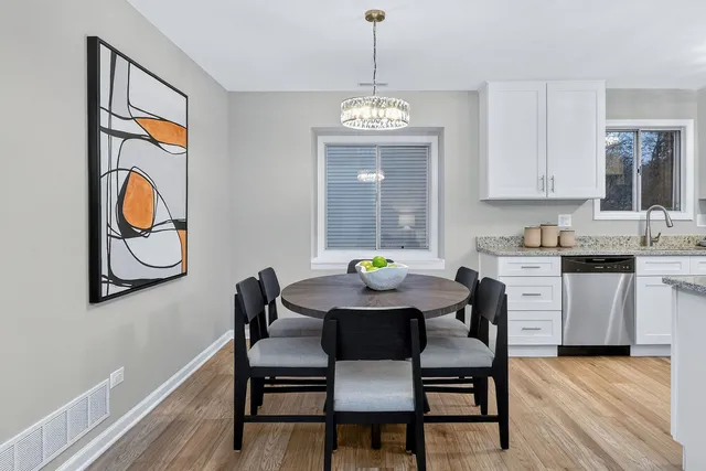 a view of a dining room with furniture wooden floor and a chandelier