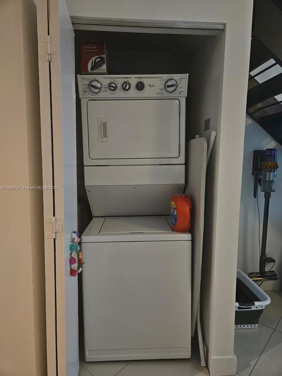 60 Southwest 13th Street, Unit 1418 Miami, FL 33130 - Photo 6 of 9 a utility room with dryer and washer
