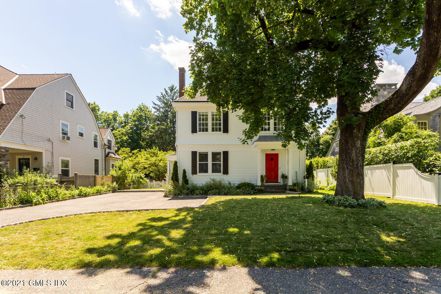 a front view of house with yard and green space
