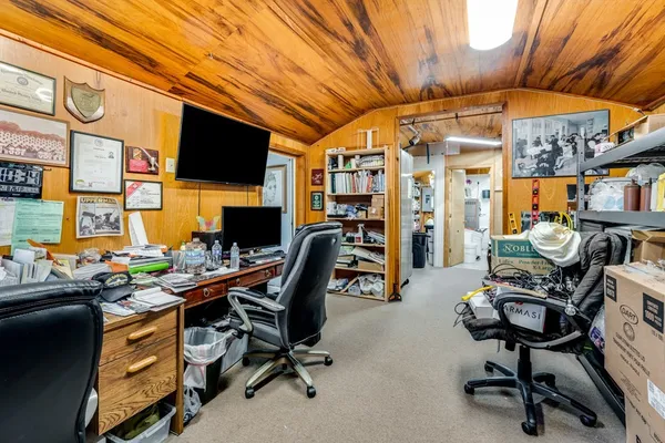 a bedroom with a bed and a tv on the dresser