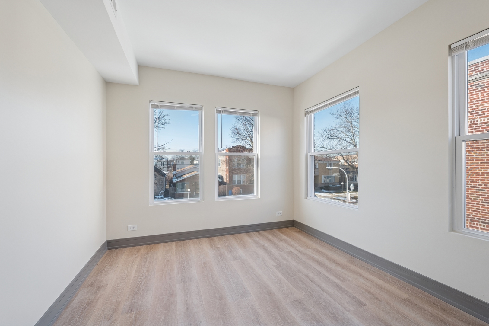 9635 South Forest Avenue, Unit 2 Chicago, IL 60628 - Photo 9 of 12 an empty room with windows
