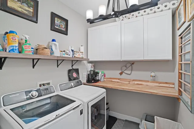a bedroom with a bed and a flat tv screen on the dresser