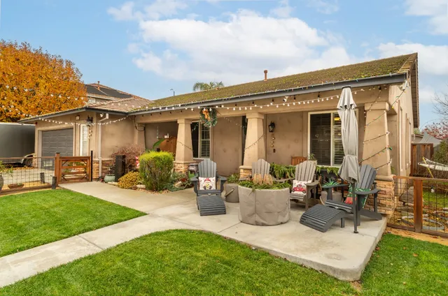 a view of a house with a swimming pool and sitting area