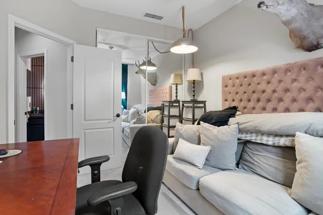 a kitchen with a dining table chairs and refrigerator