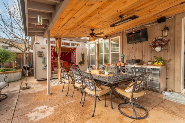 a view of a patio with table and chairs and potted plants