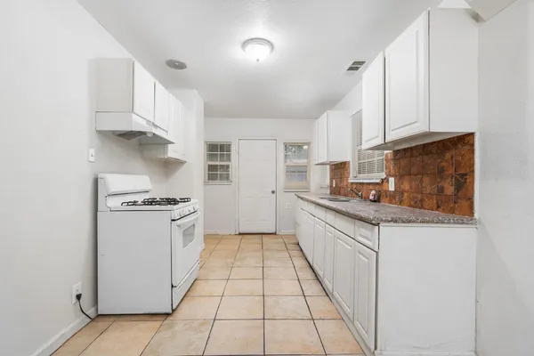 a kitchen with stainless steel appliances granite countertop a stove and a refrigerator