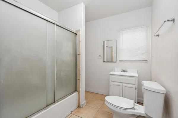a bathroom with a toilet a sink and shower
