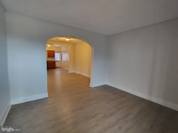 a view of a room with wooden floor and a fireplace