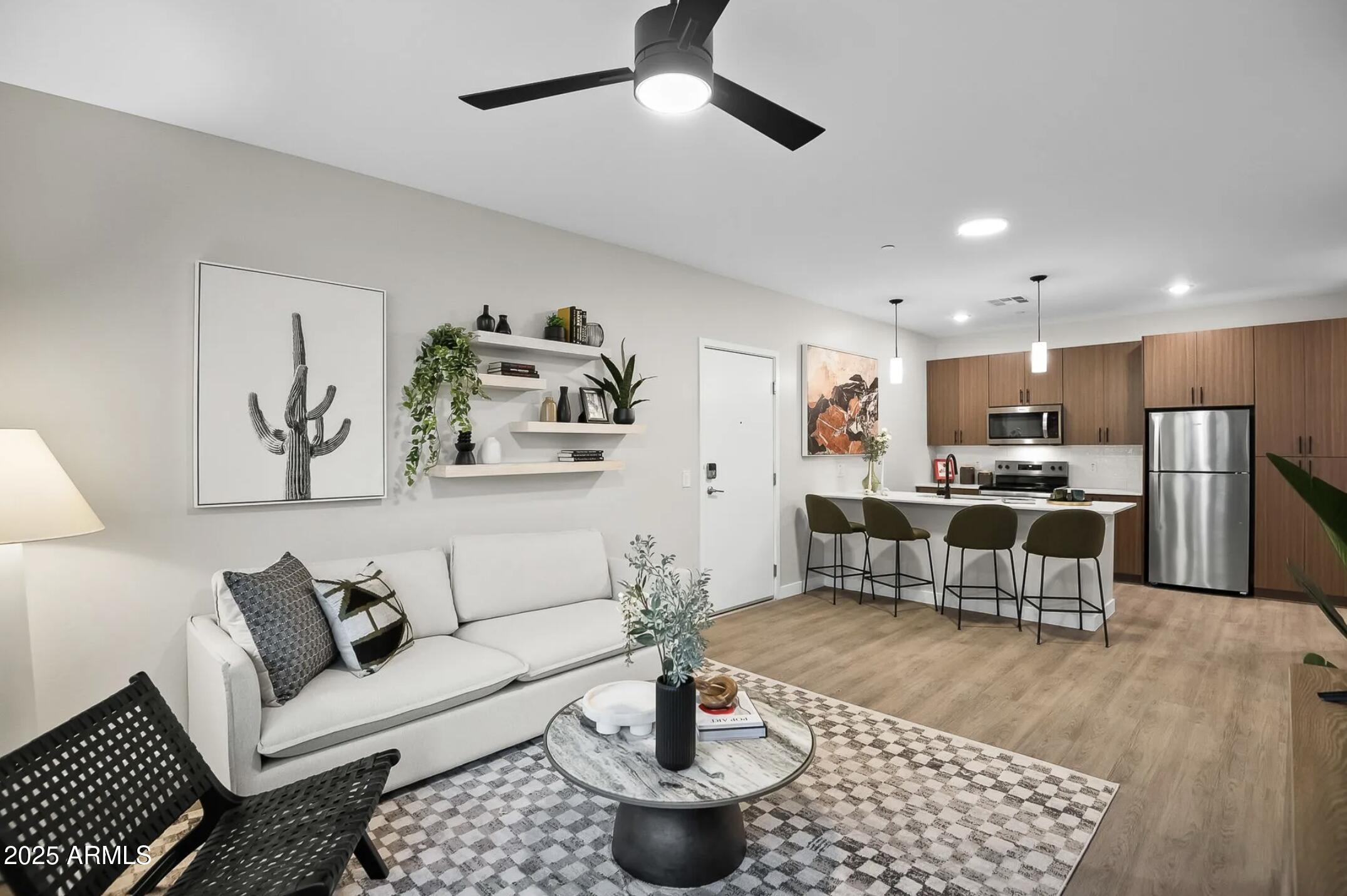 17445 West Lower Buckeye Road, Unit A2 Goodyear, AZ 85338 - Photo 17 of 35 Living Room/Kitchen view