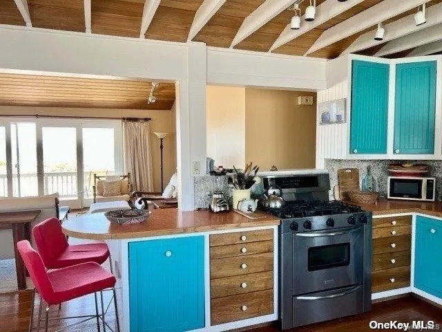 a kitchen with a stove a sink and a microwave