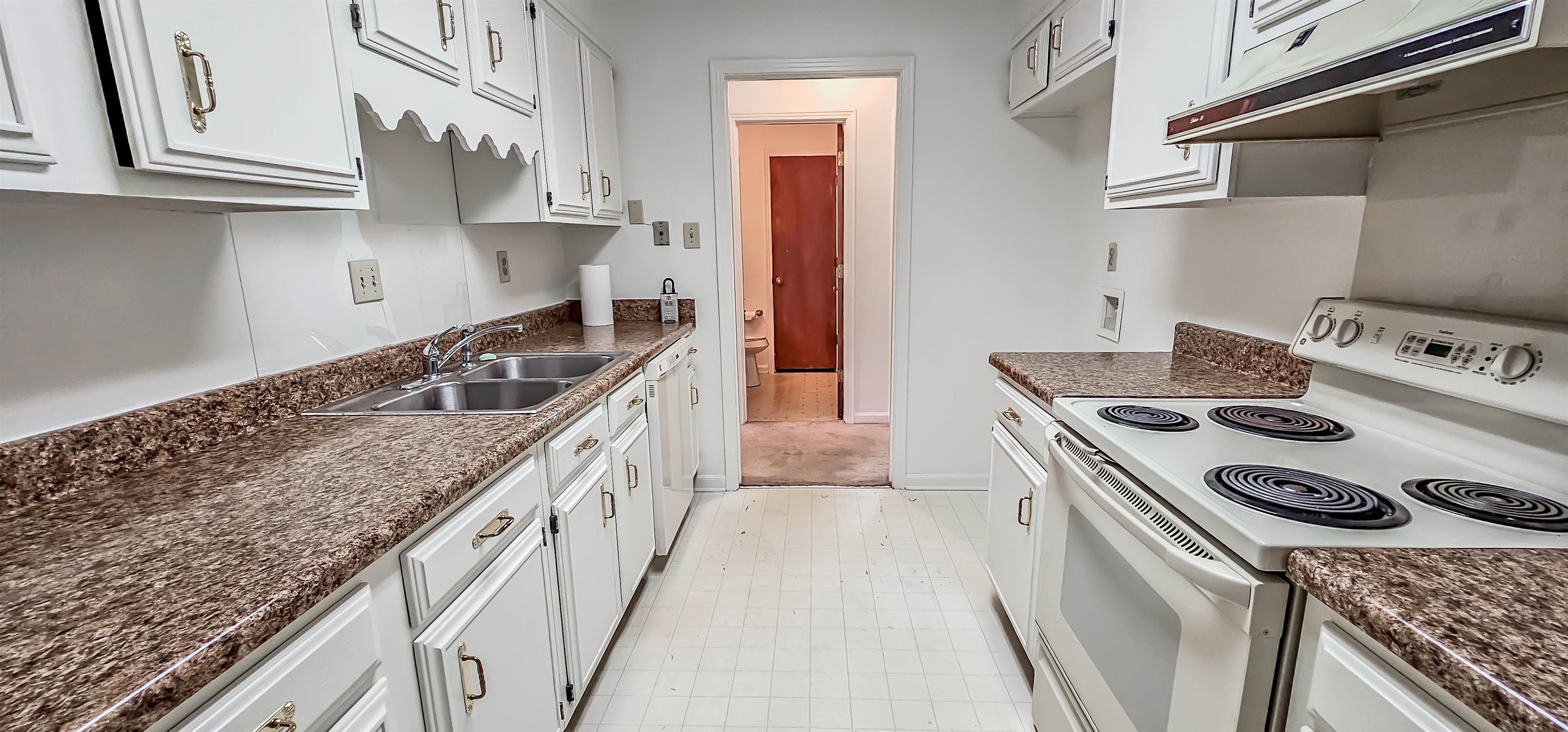 7024 Country Road Germantown, TN 38138 - Photo 13 of 27 a kitchen with a stove sink and cabinets