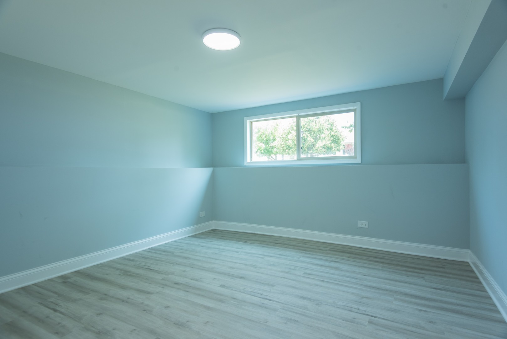 44 Redwood Trail Wheeling, IL 60090 - Photo 19 of 23 an empty room with wooden floor and windows