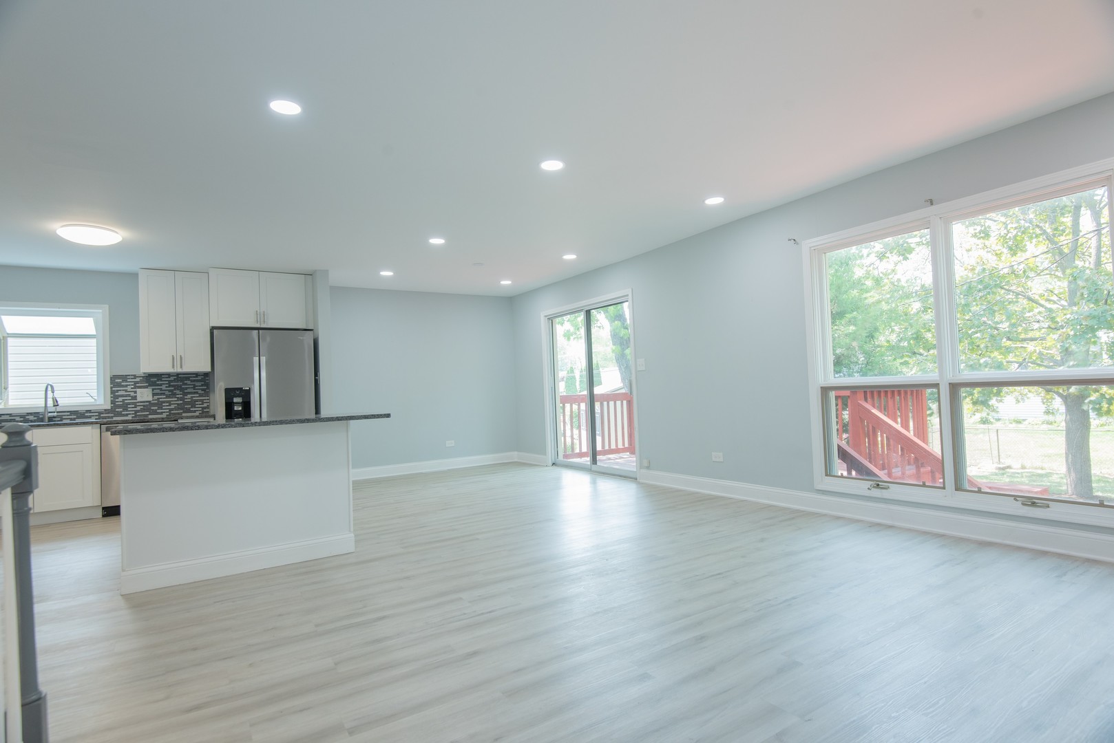 44 Redwood Trail Wheeling, IL 60090 - Photo 4 of 23 a view of an empty room with wooden floor and a window