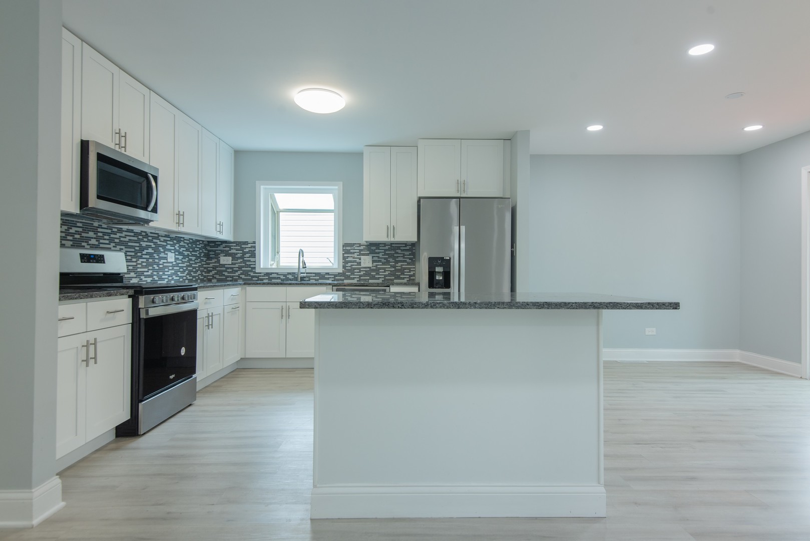 44 Redwood Trail Wheeling, IL 60090 - Photo 7 of 23 a large kitchen with cabinets and stainless steel appliances